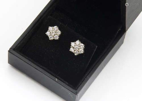 A pair of 18ct gold diamond ear studs, the cluster settings set with brilliant cuts claw set, each