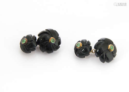 A pair of onyx and emerald cufflinks, carved black onyx centred with cabochon emerald united by