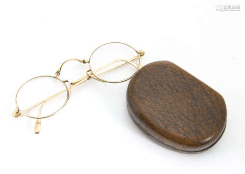 A pair of yellow metal circular rimmed folding spectacles, and case, 18g in total