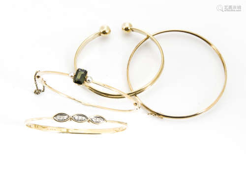 A 14ct gold diamond set bangle, 9.4g, together with a green tourmaline and seed pearl bangle, 11g,
