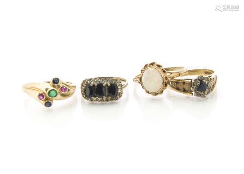 Four gem set gold rings, including two diamond and sapphire examples, a white opal dress ring and