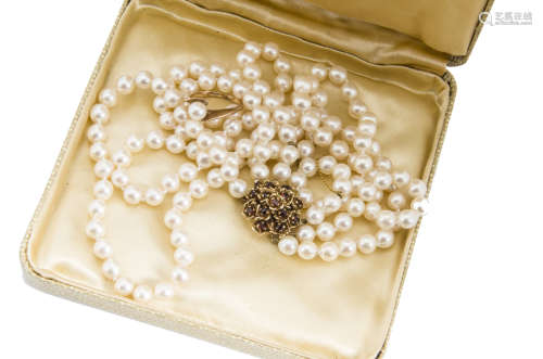 A cultured pearl three strand graduated length necklace, the uniform knotted pearls on a 9ct gold