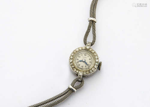 A c1950s Tudor platinum lady's cocktail dress wristwatch, 17mm case set with clear stones to the