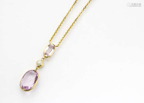 An Edwardian topaz and diamond drop pendant, the two oval pink mixed cut topaz stones in colette