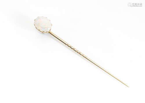 A precious opal yellow metal stick pin, the oval claw set white precious opal on a yellow metal