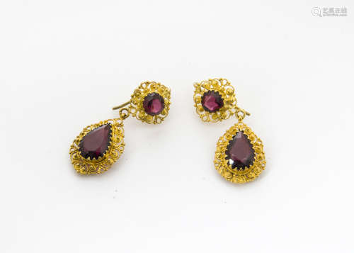 A pair of late 19th Century yellow metal and garnet drop pendant earrings, the circular mixed cut
