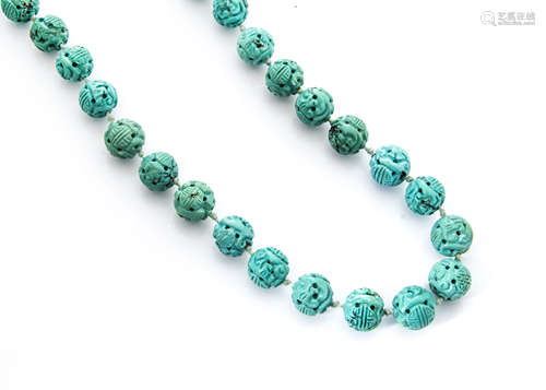 A 19th Century Chinese knotted strung turquoise bead necklace, each bead with carved scroll and