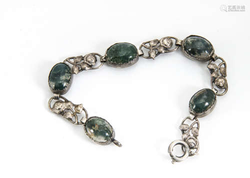 An arts and crafts style moss agate bracelet, the five oval cabochons alternately set with pierced