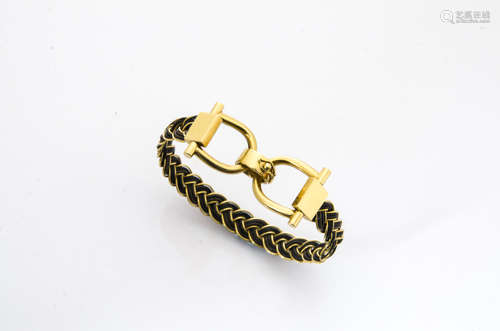 A contemporary 18ct gold plaited bangle, with buckle stirrup type clasp marked 750, internal