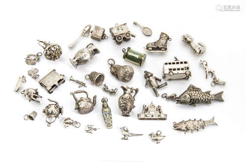 A quantity of silver charms, including a continental white metal and enamel Egyptian mummy, a