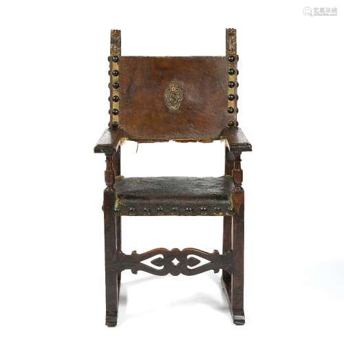 Italian walnut armchair 17th century, leather seat and back, with studded buttons, the back having a