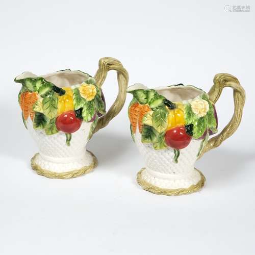 Pair of Clarice Cliff pottery jugs with moulded fruit and flowers, 20cm