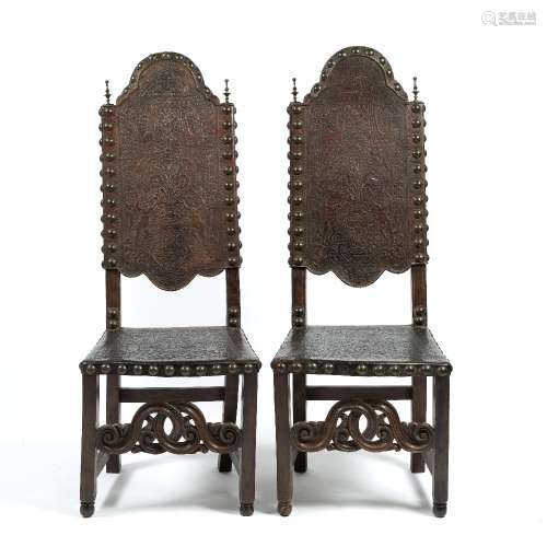Pair of Portuguese tooled leather chairs 17th Century, the backs and seats embellished with