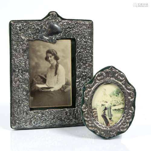 Silver photograph frame of rectangular form with embossed decoration, together with a further silver