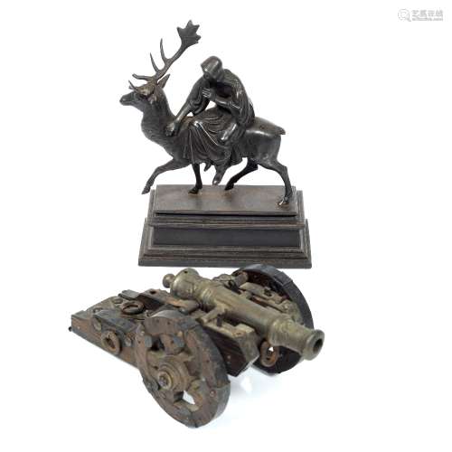 Spelter model figure on a stag 19th Century, 17cm and a small model cannon, 21cm (2)