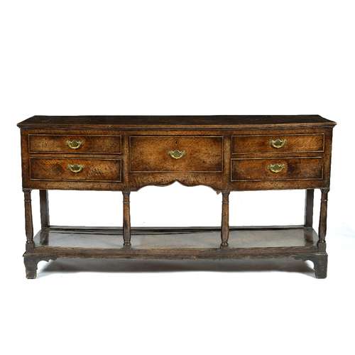 Oak dresser base 18th century, fitted with a central drawer and four further drawers either side,