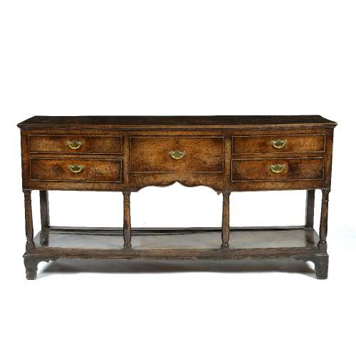 Oak dresser base 18th century, fitted with a central drawer and four further drawers either side,
