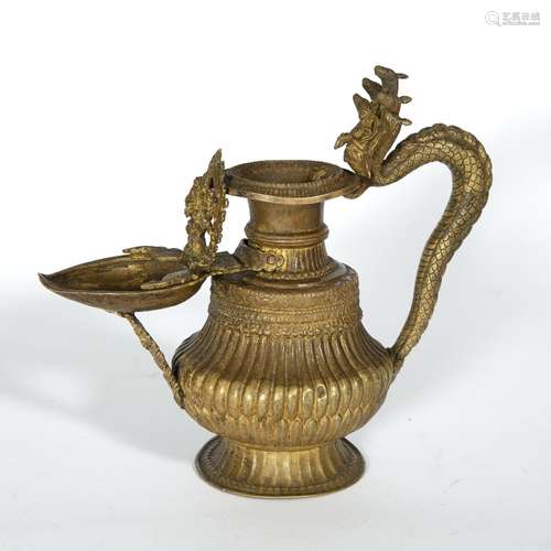 Nepalese oil lamp the handle modelled as a cobra, with a leaf shaped spout, 24cm high