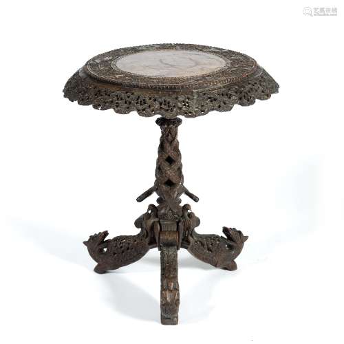 Burmese carved hardwood occasional table 19th Century, the circular top carved with a deep frieze
