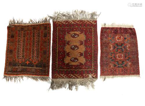 Three small Afghan rugs each with traditional patterns, largest approx. 70cm x 50cm (3)