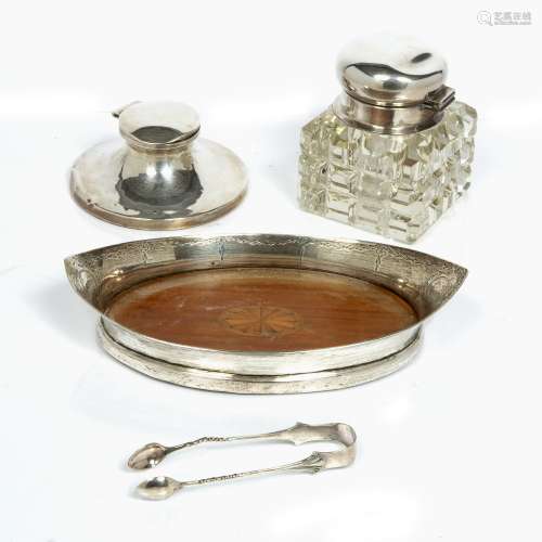 Glass inkwell with silver mounted lid, a silver cap stand inkwell, a silver boat shaped dish with