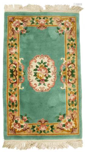 Chinese green ground rug with central foliate medallion, 157cm x 90cm