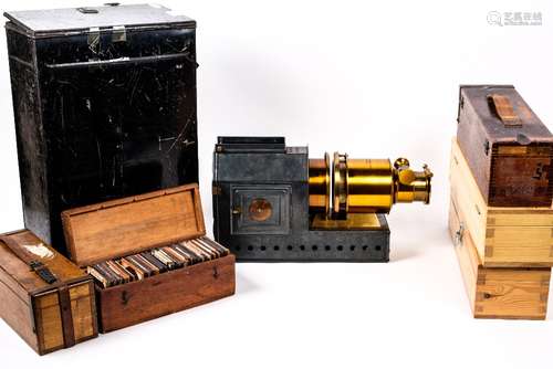 Magic lantern 'The Praestantia' in original tin case and a large quantity of magic lantern slides