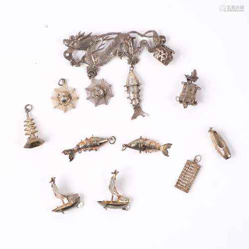 Chinese white metal brooch in the form of a dragon and various charms (9)