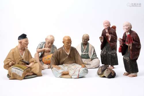 Six Japanese painted plaster figures to include trades and others, largest 26cm