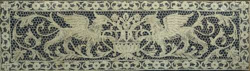 Nottingham type lace work panel depicting two griffins, framed, 41cm x 145cm