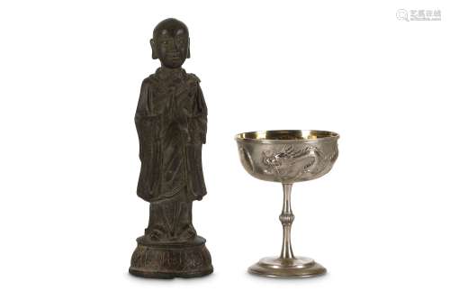 A CHINESE BRONZE FIGURE AND A SILVER GOBLET Ming Dynasty and later. The figure of Ananda in monk's