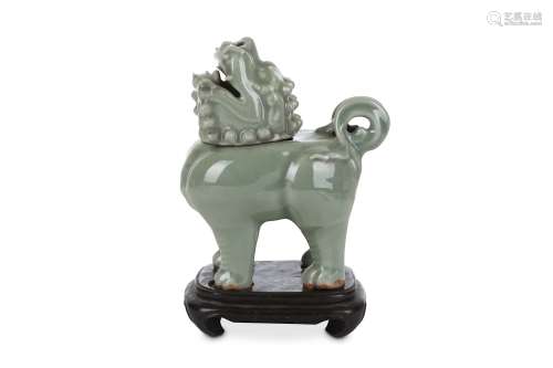 A CHINESE CELADON-GLAZED 'LION' INCENSE BURNER AND COVER. Qing Dynasty. Standing four-square, with a