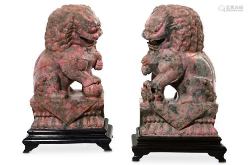 A PAIR OF PINK JADE BUDDHIST LION DOGS. 20th Century. Each seated on its haunches, baring its