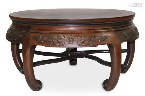 A CHINESE CIRCULAR HONGMU TABLE. Late Qing Dynasty. With an apron carved with pairs of confronting