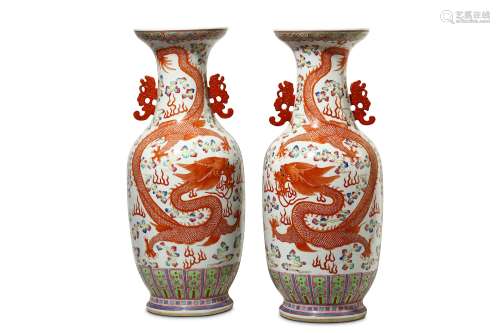 A PAIR OF CHINESE FAMILLE ROSE ‘DRAGON AND PHOENIX’ VASES. Of baluster form, decorated in mirror