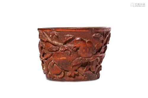 A CHINESE CARVED BAMBOO ‘BIRD AND POMEGRANATE’ CUP. Qing Dynasty, 18th to 19th Century. The uneven