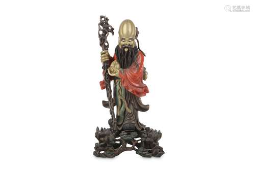 A CHINESE LACQUER FIGURE OF . Circa 1950. Standing, wearing long robes, holding a peach in his