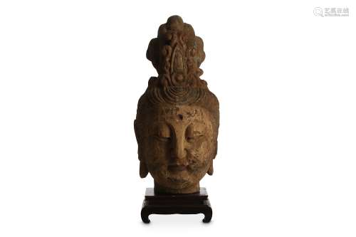 A CHINESE POLYCHROMED WOOD HEAD OF A BODHISATTVA. Qing Dynasty. Carved with downcast eyes in a