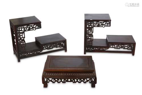 THREE CHINESE WOOD STANDS.  Late Qing Dynasty. Comprising a pair of L-shaped two tier stands with