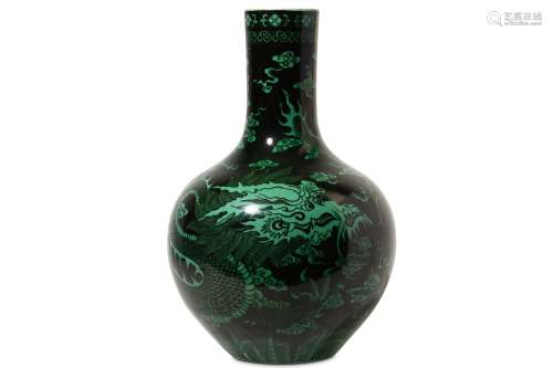 A CHINESE BLACK-GROUND GREEN-GLAZED ‘DRAGON’ VASE. Of pear-shaped form decorated with a ferocious