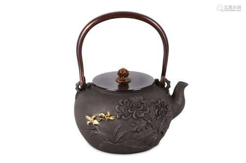 A JAPANESE IRON TEA POT (TETSUBIN). 20th Century. Decorated in high relief with flowering