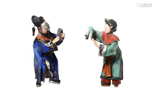 A PAIR OF CHINESE PAINTED CLAY FIGURES. Qing Dynasty, 19th Century. Formed as a male and a female