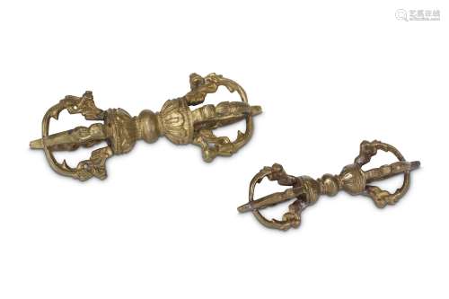 TWO TIBETAN BRONZE VAJRAS. 19th Century. Each with eight prongs issuing from mouths of mythical