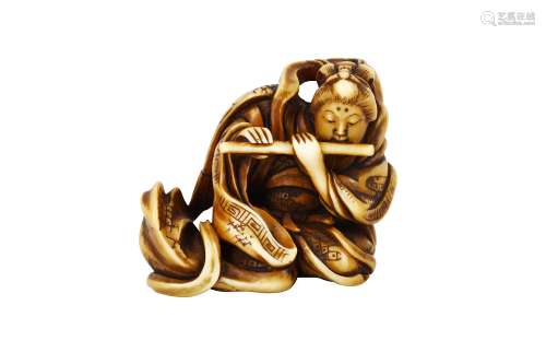 AN IVORY NETSUKE OF A TEN’NYO. 19th Century. The heavenly angel playing a flute, as her robe