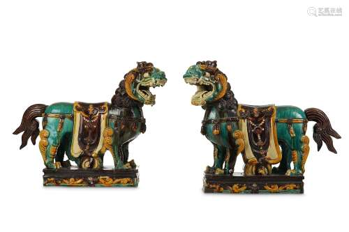 A PAIR OF MASSIVE CHINESE SANCAI LION DOGS. Qing Dynasty. Each standing four-square, with a fierce