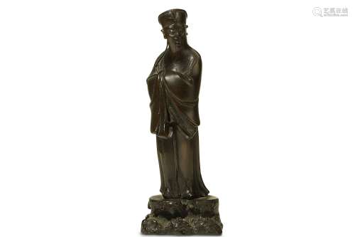A CHINESE BRONZE FIGURE OF A SCHOLAR. 17th Century. Standing, wearing long flowing robes and a