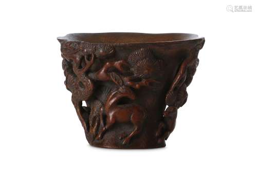 A CHINESE BAMBOO 'DEER' LIBATION CUP. 17th Century. The deeply hollowed, flared body carved in