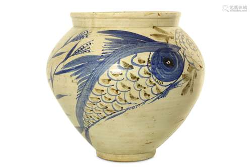 A LARGE CREAM-GLAZED 'FISH' POTTERY JAR. Korea, circa 1900. With a tapered ovoid body freely painted