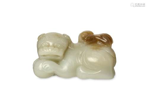 A CHINESE JADE ‘LION AND CUB’ CARVING. Seated with legs tucked beneath and the head turned to the