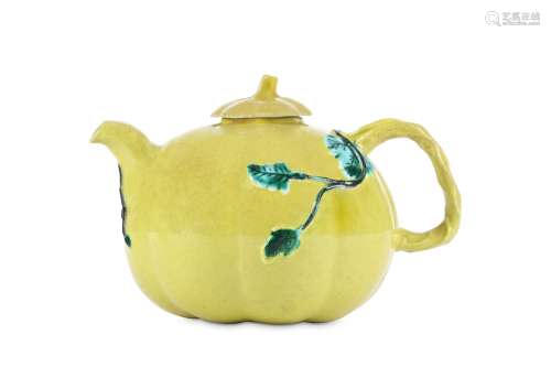 A CHINESE YELLOW-GLAZED TEAPOT AND COVER. Qing Dynasty. The ovoid body moulded as a lobed pumpkin